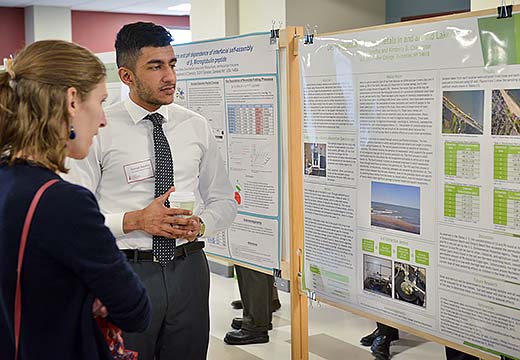 Student presents a poster of his research.